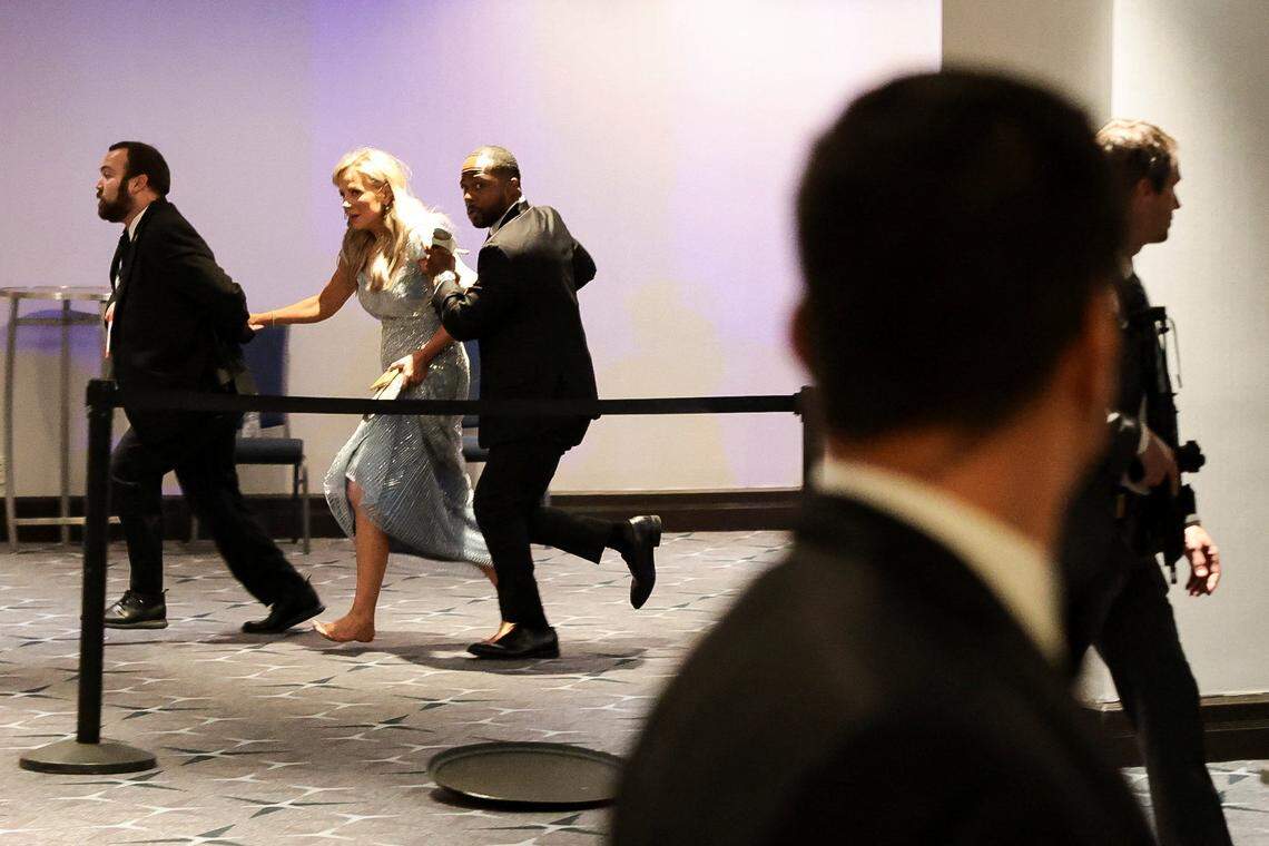 Security officials evacuate a guest as a shooter opens fire during the annual White House Correspondents' Association dinner in Washington, D.C., U.S., April 25, 2026. 