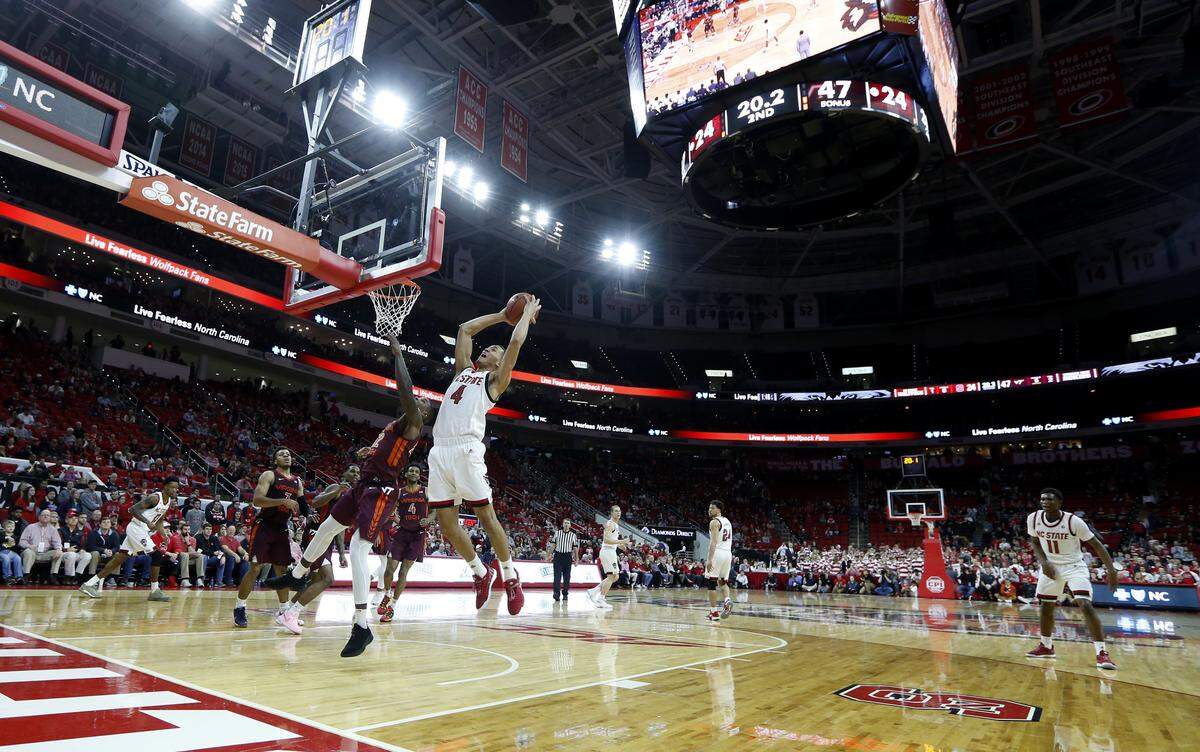 N.C. State’s Jericole Hellems (4) pulls in a rebound late in the second half of Virginia Tech’s 47-24 victory over N.C. State at PNC Arena in Raleigh, N.C., Saturday, Feb. 2, 2019.