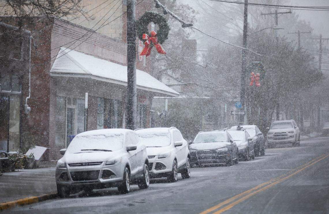 Snow accumulates on cars in downtown Hillsborough, N.C. on Monday, Jan. 3, 2022.