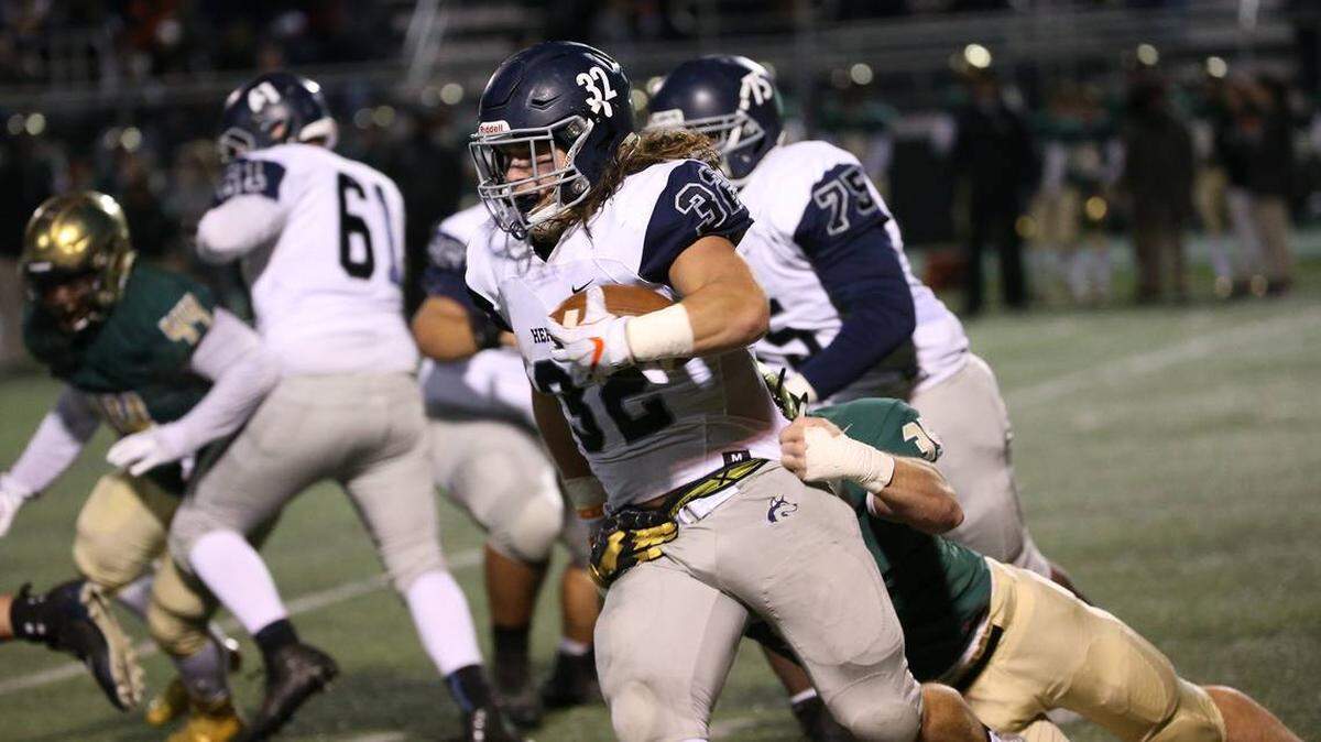 Heritage’s Drake Thomas carries the ball during a playoff game last season. Thomas will be joining his brother Thayer at N.C. State.