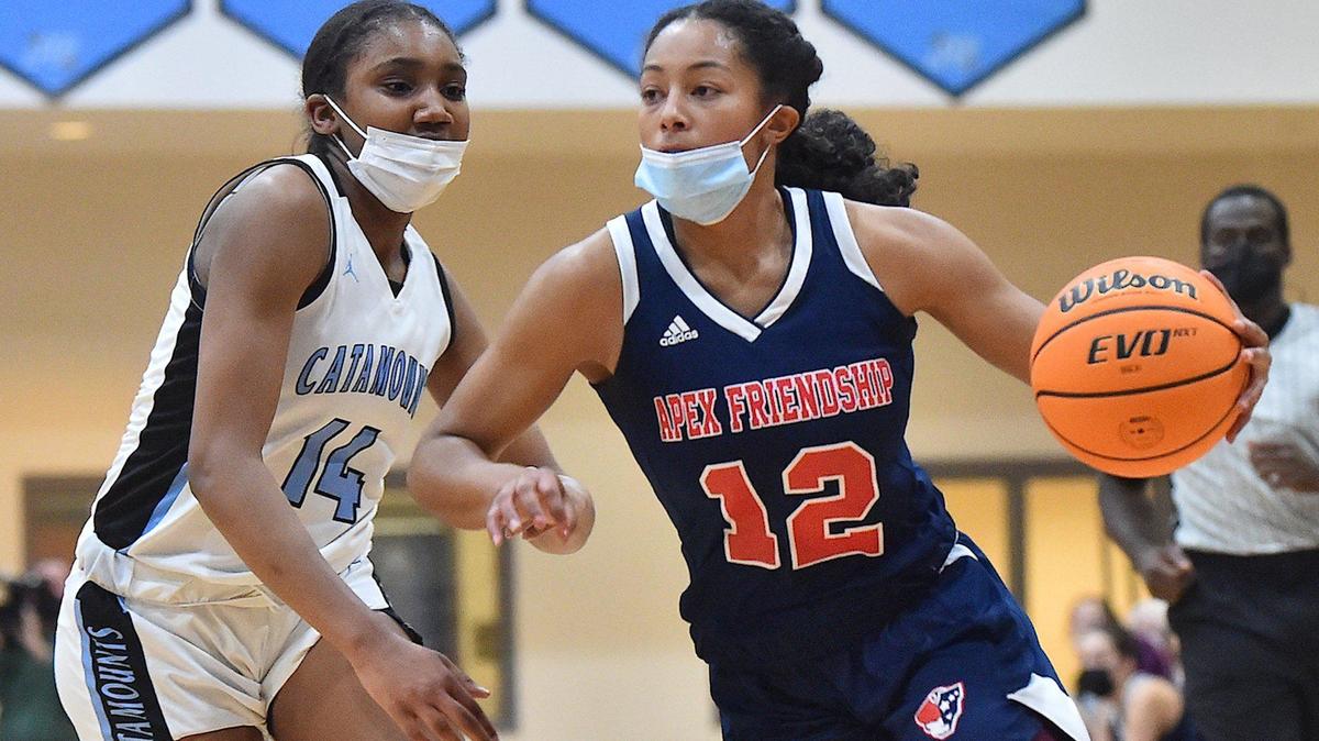 Apex Friendship’s Indya Nivar (12) drives to the basket against Panther Creek’s Madisyn Jordan (14) during the first half. The Panther Creek Catamounts and the Apex Friendship Patriots met in a conference basketball game in Cary, NC on January 28, 2022.