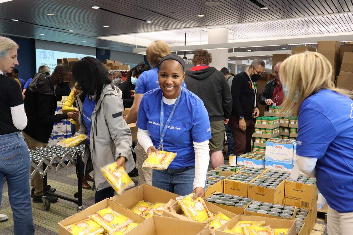 Volunteers packing and sorting food at an Inter-Faith Food Shuttle volunteer event.