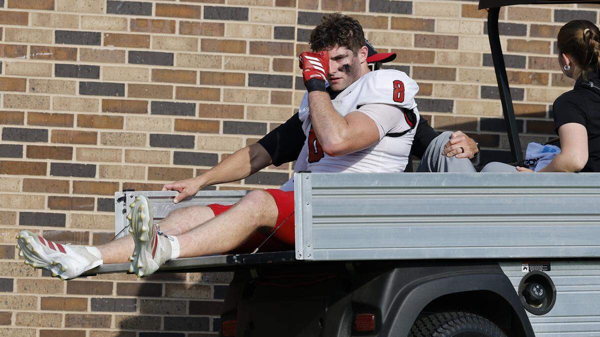 N.C. State’s Cian Slone (8) is carted to the locker room during the first half of N.C. State’s game against Duke at Wallace Wade Stadium in Durham, N.C., Sat. Sept. 20, 2025