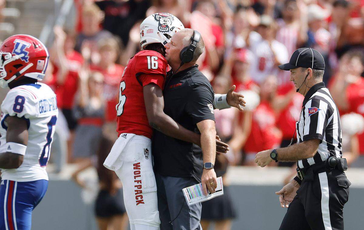 N.C. State head coach Dave Doeren chest bumps quarterback CJ Bailey (16) during the second half of N.C. State’s 30-20 victory over LA Tech at Carter-Finley Stadium in Raleigh, N.C., Saturday, Sept. 14, 2024.