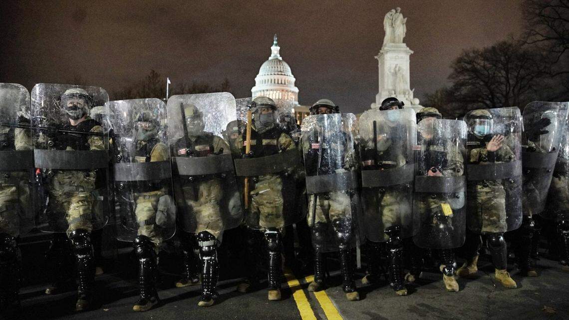 National Guard troops clear a street near the Capitol in Washington following after rioters entered the building Wednesday, Jan. 6, 2021.