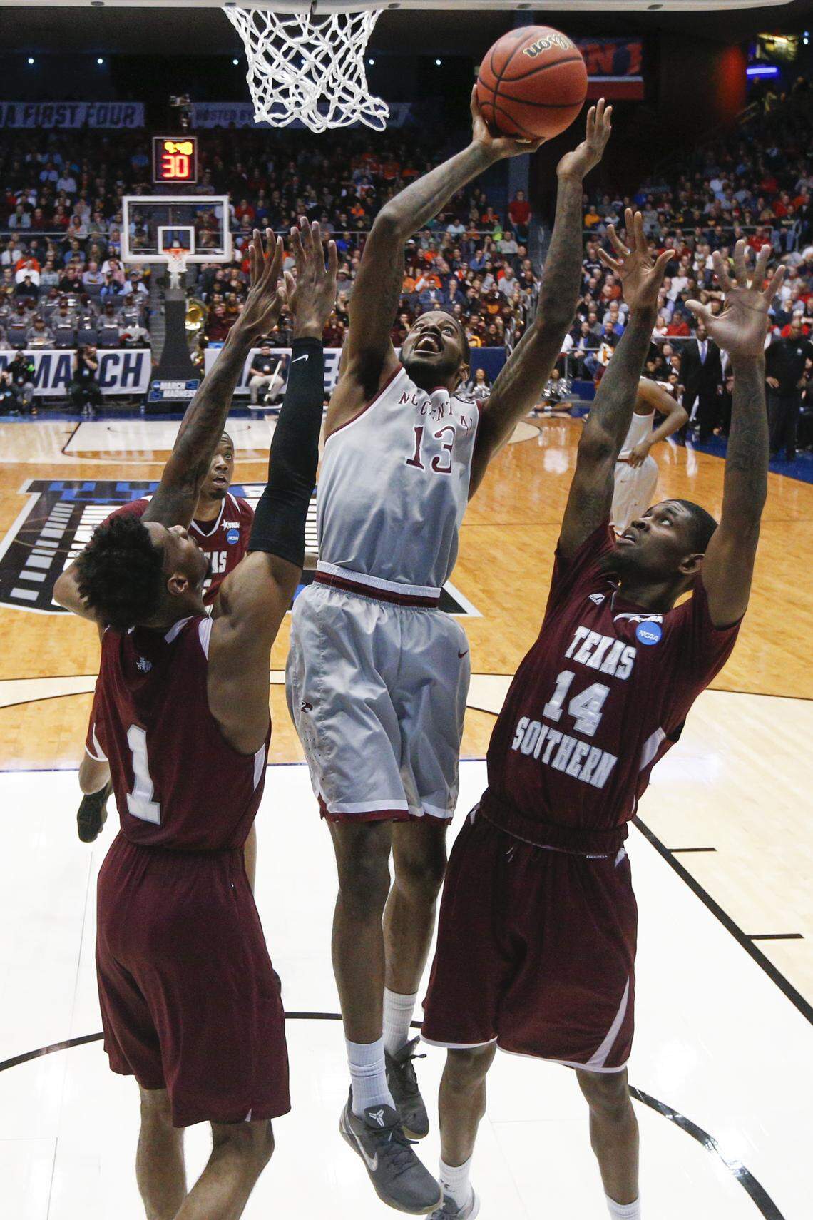 North Carolina Central's Pablo Rivas (13) shoots against Texas Southern's Lamont Walker (14) and Donte Clark (1) during the second half.