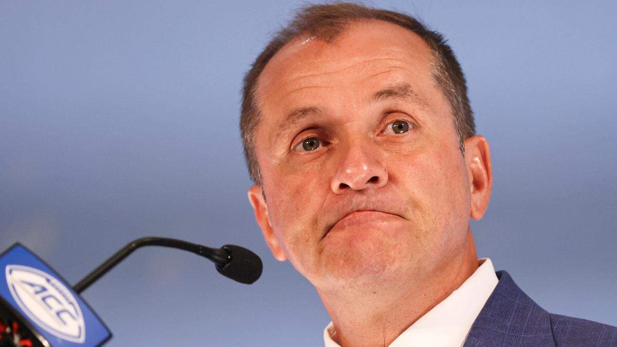 Atlantic Coast Conference commissioner Jim Phillips listens to a question during a press conference at the NCAA college football ACC media days in Charlotte, N.C., Wednesday, July 21, 2021.