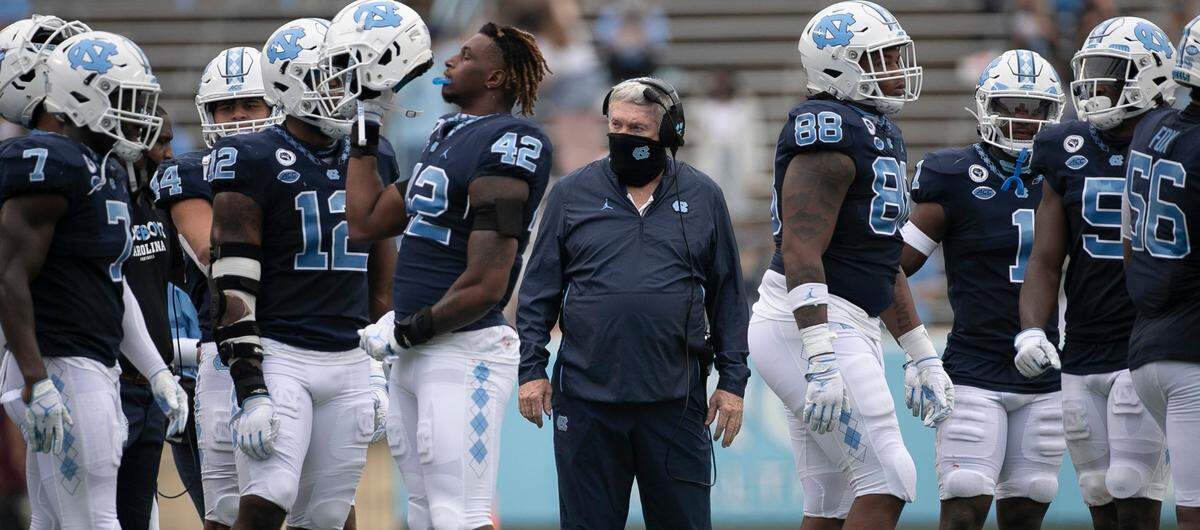 North Carolina coach Mack Brown huddles with the defensive unit during a time-out in the second quarter on Saturday, October 10, 2020 at Kenan Stadium in Chapel Hill, N.C.