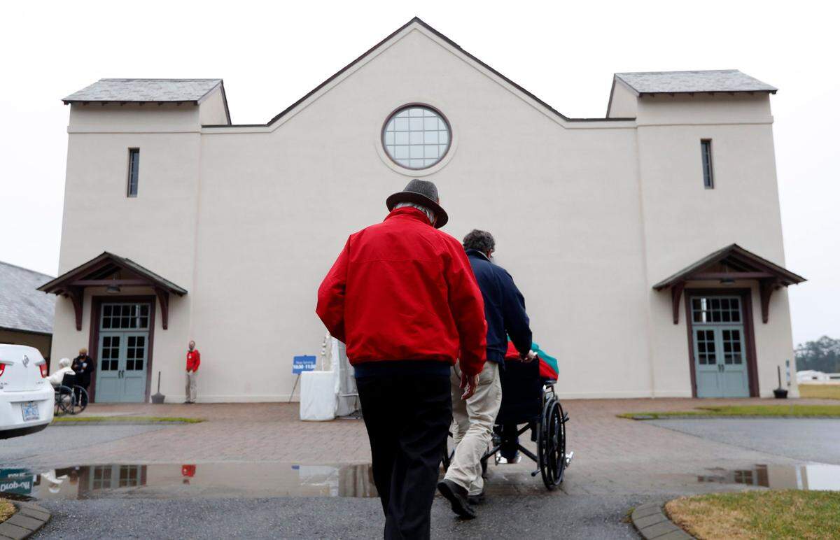Attendees head to the Fair Barn during a COVID-19 vaccination clinic administered by FirstHealth of the Carolinas at the Fair Barn in Pinehurst, N.C., Tuesday, January 26, 2021.