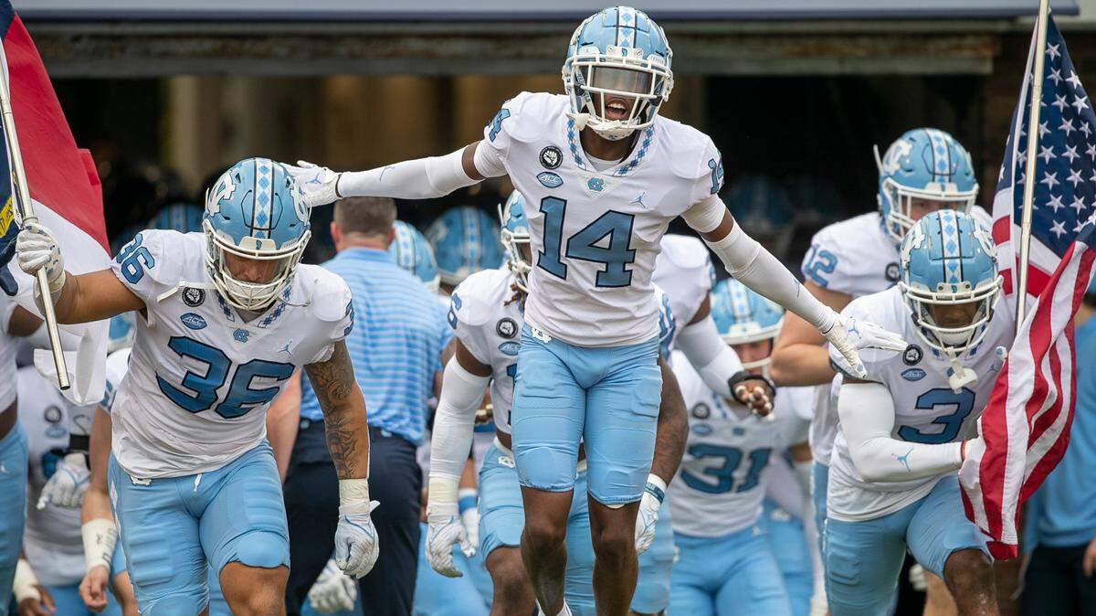 Dante Balfour (14) and the North Carolina Tar Heels enter Scott Stadium for their game against Virginia on Saturday, November 5, 2022 at Scott Stadium in Charlottesville, Va.