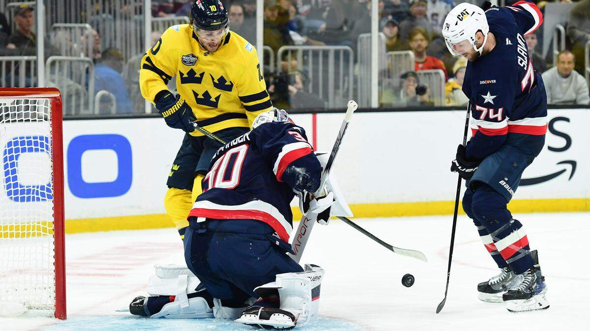 Team Sweden forward Adrian Kempe (10) and Team USA defenseman Jaccob Slavin (74) battle for a rebound in front of goalie Jake Ottinger (30) during the second period in a 4 Nations Face-Off ice hockey game at TD Garden.