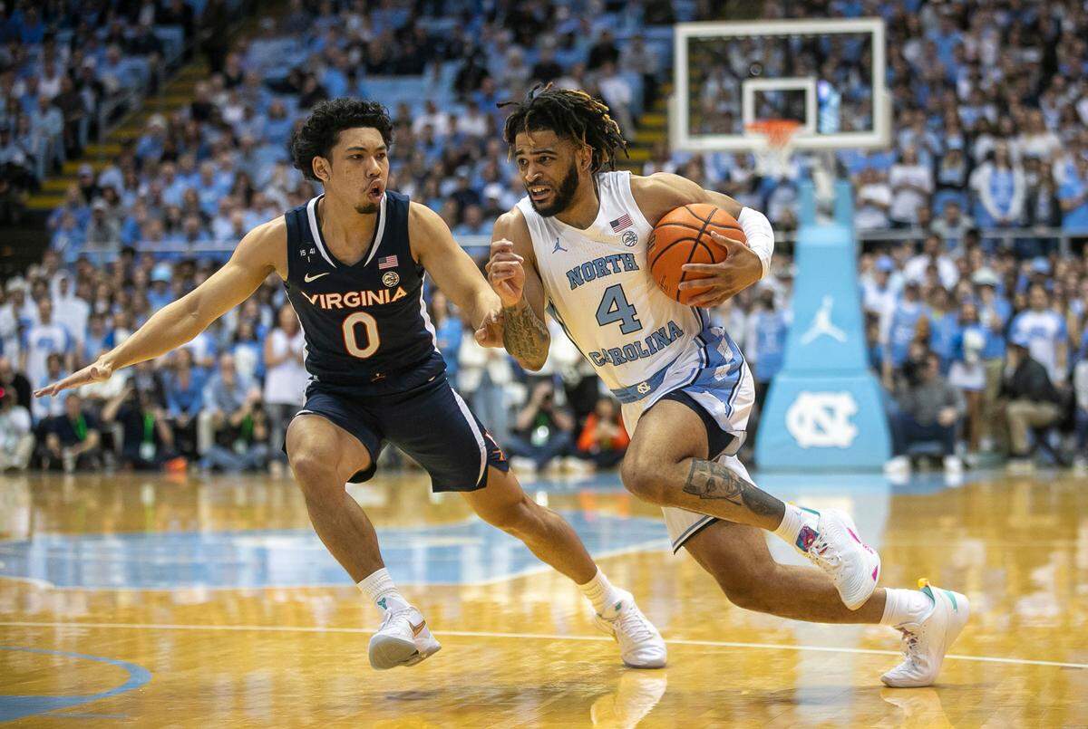 North Carolina’s R.J. Davis (4) drives to the basket against Virginia’s Kihei Clark (0) during the first half on Saturday, February 25, 2023 at the Smith Center in Chapel Hill, N.C.