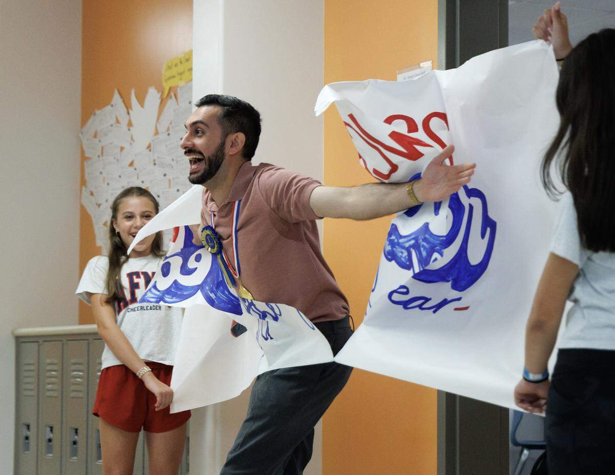 Matin Maani, a seventh-grade social studies teacher at Apex Friendship Middle School, reacts as he is recognized with a parade through the school on Thursday, May 21, 2026, in Apex, N.C. Maani was named the 2026 Wake County Teacher of the Year. 