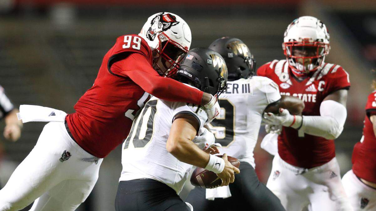 N.C. State defensive end Daniel Joseph (99) sacks Wake Forest quarterback Sam Hartman (10) during the second half of N.C. State’s 45-42 victory over Wake Forest at Carter-Finley Stadium in Raleigh, N.C, Saturday, Sept. 19, 2020.