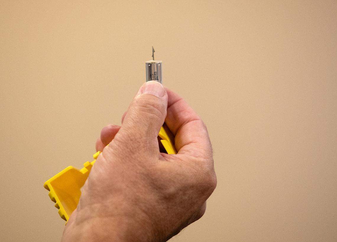 Pinehurst Police Deputy Chief Ken Hall holds a taser deployment during a demonstration at the Pinehurst Police Department on Tuesday, Oct. 29, 2024, in Pinehurst, N.C.