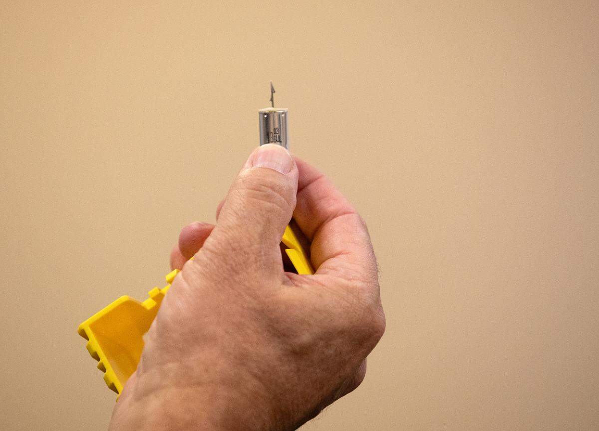 Pinehurst Police Deputy Chief Ken Hall holds a taser deployment during a demonstration at the Pinehurst Police Department on Tuesday, Oct. 29, 2024, in Pinehurst, N.C.