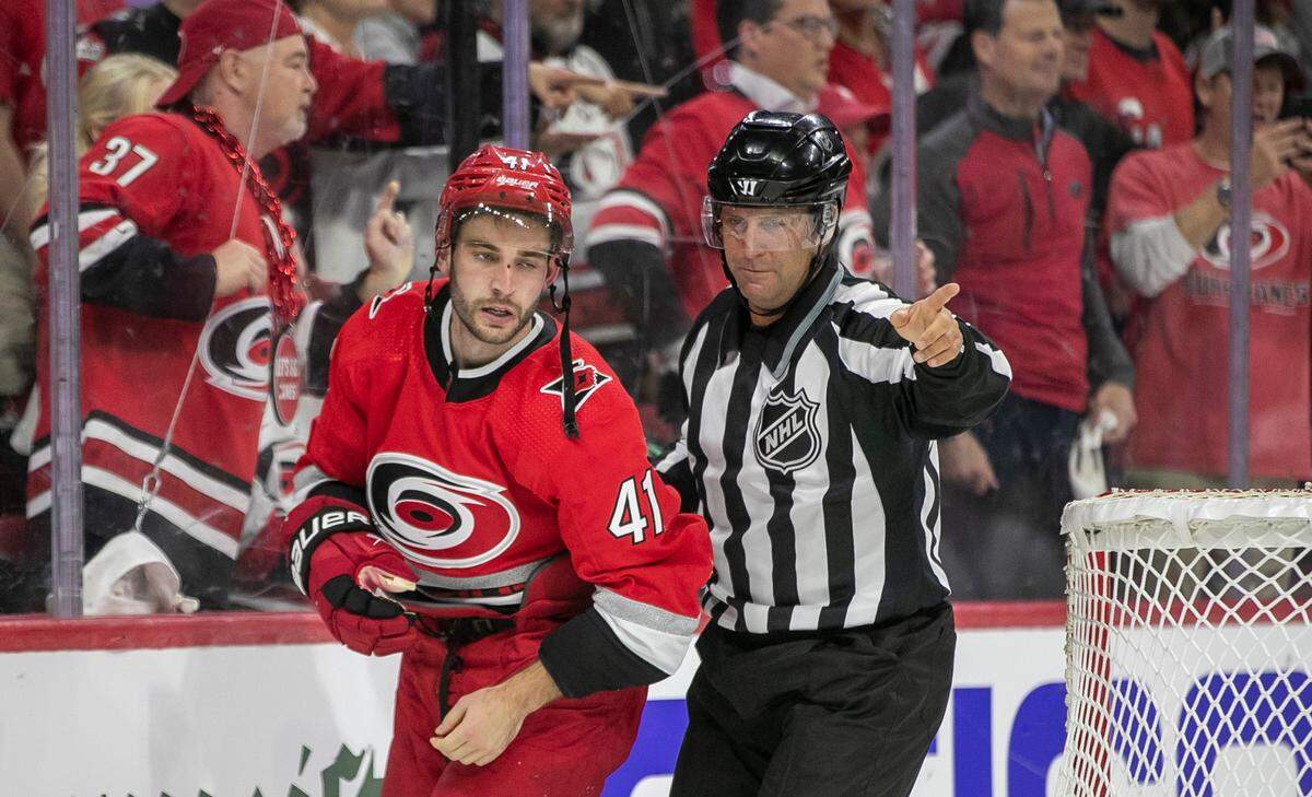 Carolina Hurricanes’ Shayne Gostisbehere (41) is escorted away from a fight by the official at the end of the first period during game two of their Stanley Cup series on Wednesday, April 19, 2023 at PNC Arena in Raleigh, N.C.