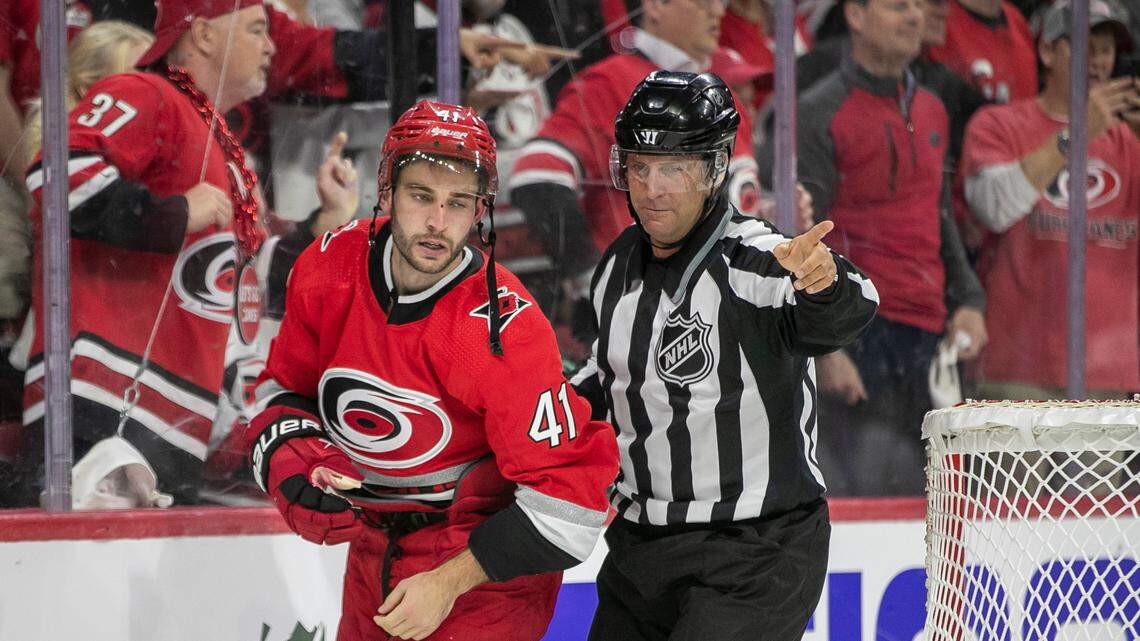 Carolina Hurricanes’ Shayne Gostisbehere (41) is escorted away from a fight by the official at the end of the first period during game two of their Stanley Cup series on Wednesday, April 19, 2023 at PNC Arena in Raleigh, N.C.