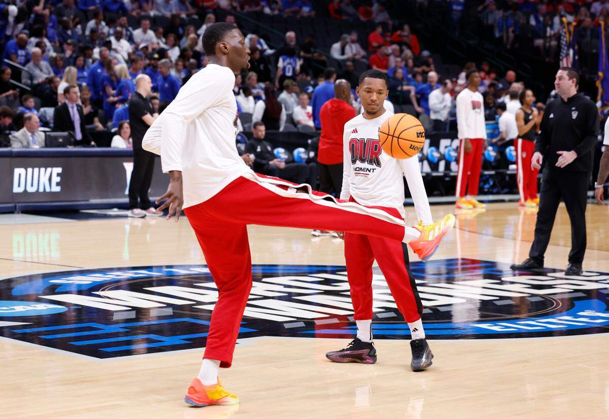 N.C. State’s Mohamed Diarra kicks around the basketball with KJ Keatts during warmups before N.C. State’s game against Duke in their NCAA Tournament Elite Eight matchup at the American Airlines Center in Dallas, Texas, Sunday, March 31, 2024.