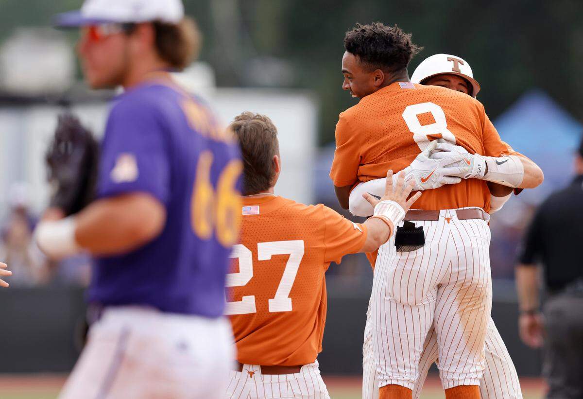 Texas players celebrate with Texas’ Dylan Campbell (8) after Campbell hit a RBI single in the ninth inning to give Texas a 9-8 victory over ECU in the Greenville Super Regional at Clark-LeClair Stadium Saturday, June 11, 2022.