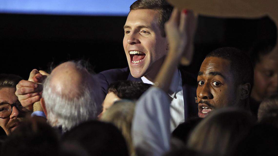 Conor Lamb, the Democratic candidate for the March 13 special election in Pennsylvania's 18th Congressional District, center, celebrates with his supporters at his election night party in Canonsburg, Pa., early Wednesday, March 14, 2018. A razor's edge separated Lamb and Republican Rick Saccone early Wednesday in their closely watched special election in Pennsylvania, where a surprisingly strong bid by first-time candidate Lamb severely tested Donald Trump's sway in a GOP stronghold.