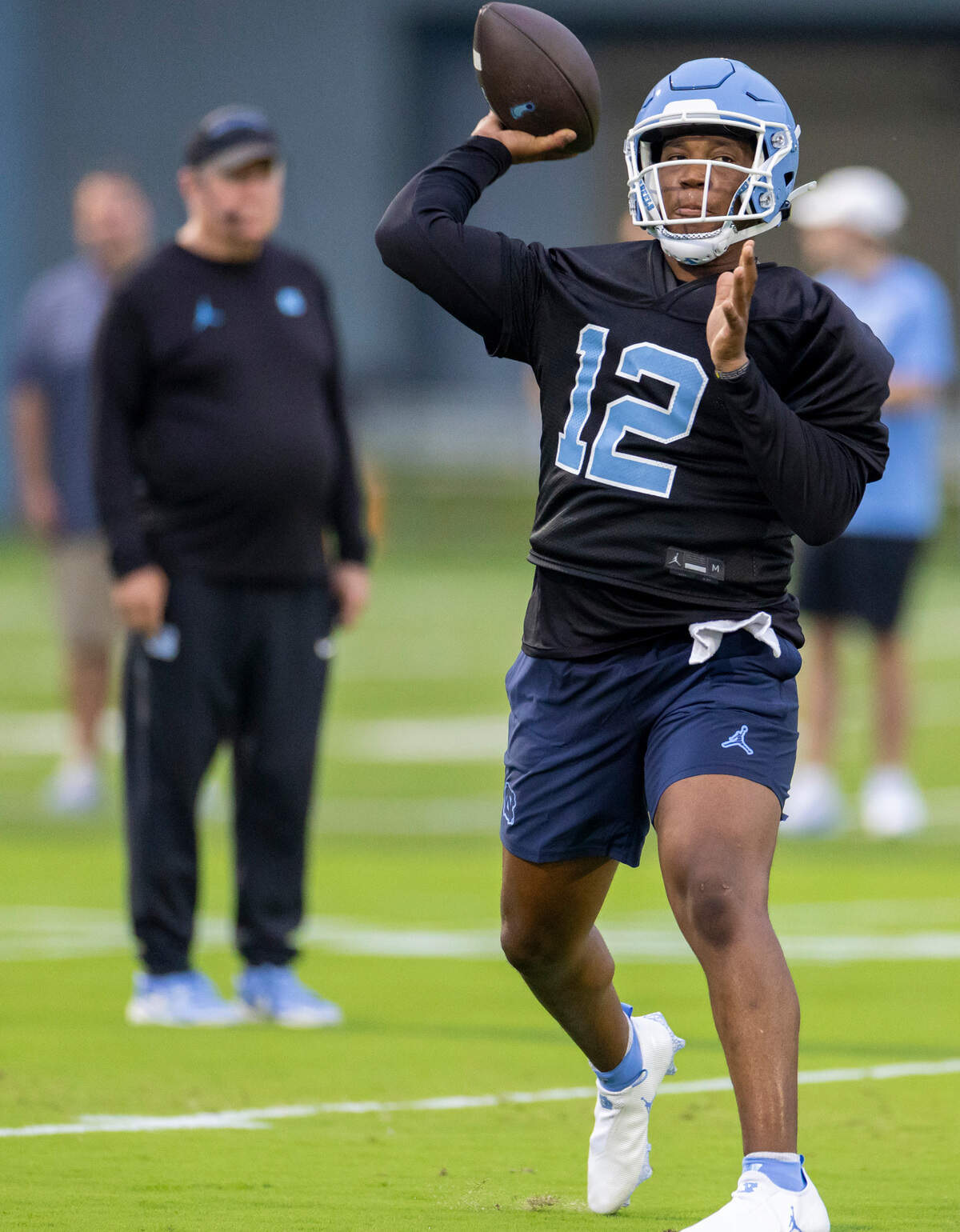 North Carolina coach Mack Brown watches graduate transfer quarterback Jacolby Criswell (12) during the Tar Heels’ first practice of the season on Monday, July 29, 2024 in Chapel Hill, N.C.