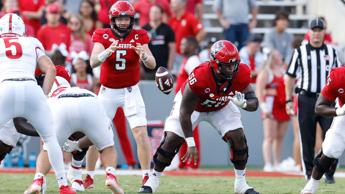 N.C. State’s Lyndon Cooper (56) snaps the ball to quarterback Brennan Armstrong (5) during the second half of the Wolfpack’s 45-7 victory over VMI at Carter-Finley Stadium in Raleigh, N.C., Saturday, Sept. 16, 2023.
