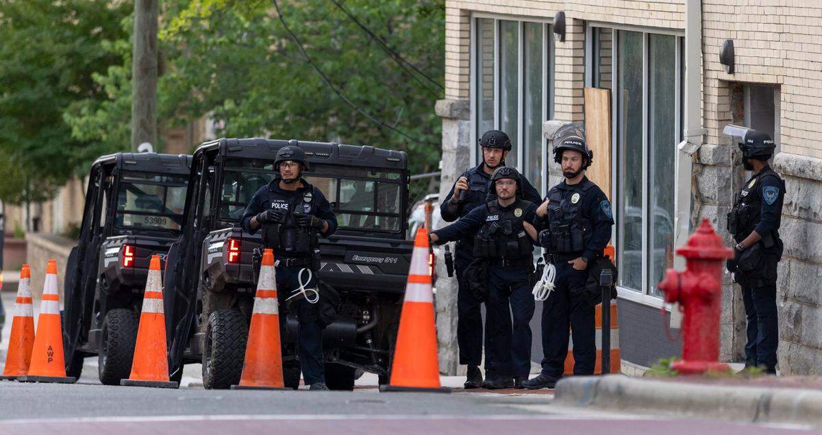 Durham Police monitor demonstrators on CCB Plaza from their position on Corcoran Street, prior to the ‘Solidarity with La Resistance’ immigration march on Friday.
