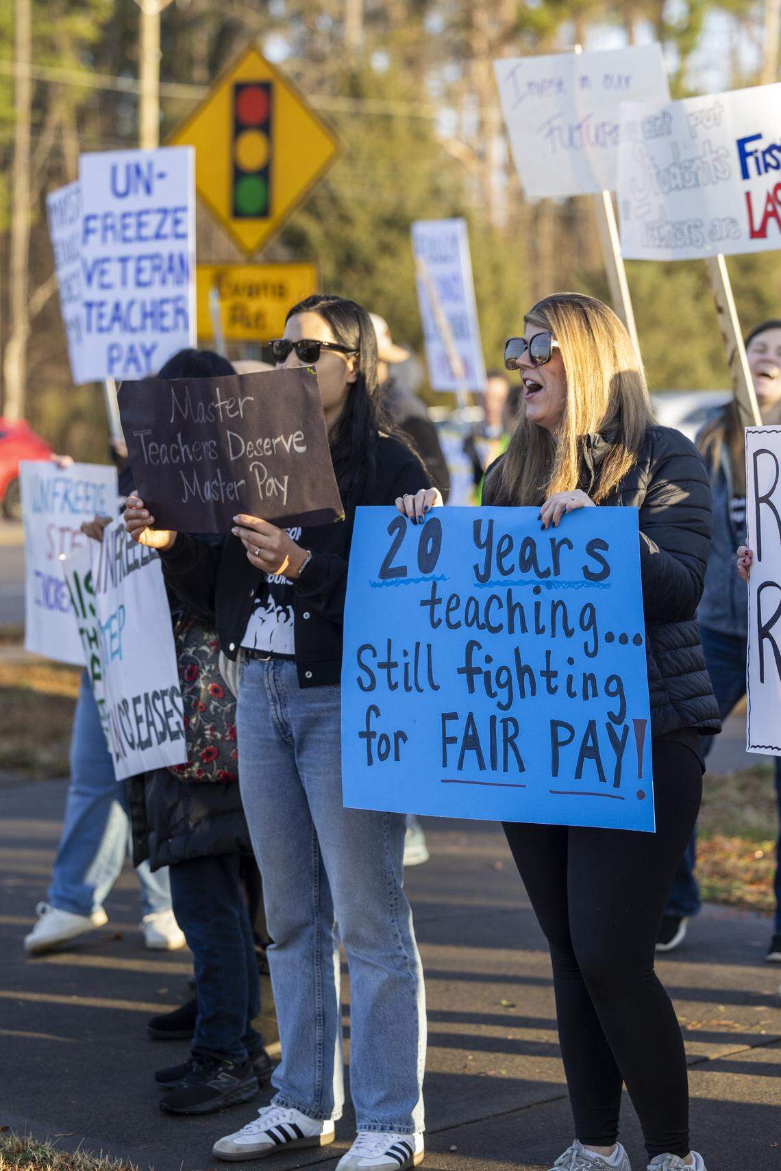 Dozens of educators demonstrate at the intersection of Green Level Church and Carpenter Fire Station roads in Cary on Wednesday morning, Jan. 7, 2026, calling on state lawmakers to provide more funding for public education. Leaders of NC Teachers in Action say 650 to 750 educators from 52 schools, including 30 in Wake County, called out of work Wednesday to participate in the protests.