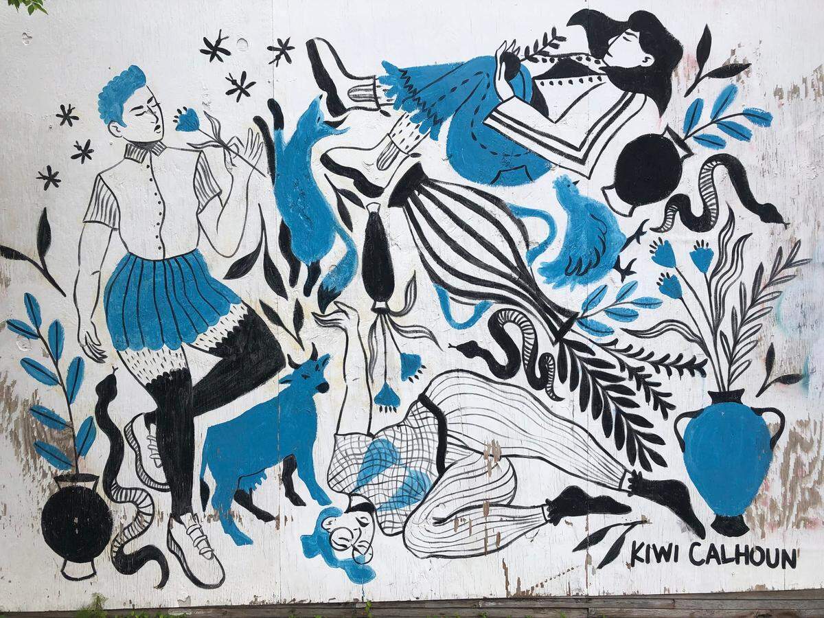 The Blue Daydreamers mural at 107 E Martin St by Kalee Calhoun features minimalisticly colored blue figures floating in white space