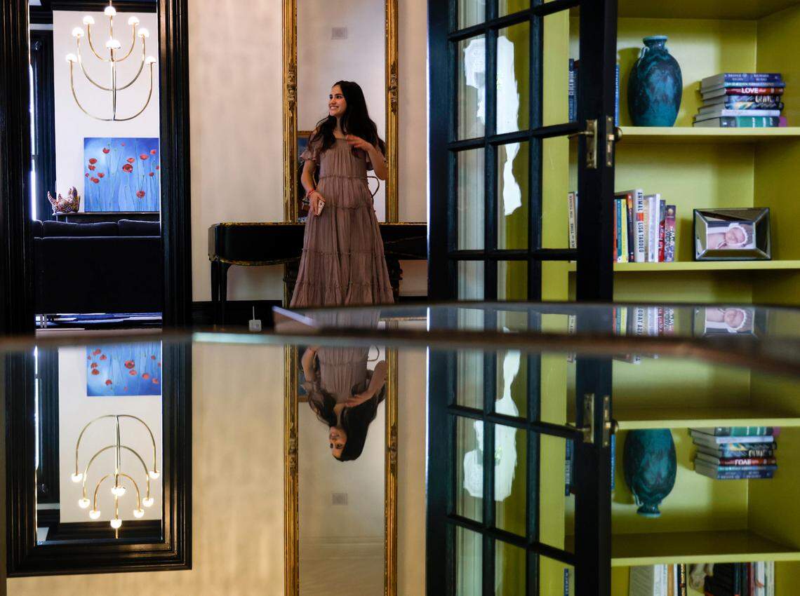 Sophie Retzlaff leads guests on tours of the Andrews-Duncan House during a fundraising event for CASA, an affordable housing nonprofit, on Tuesday, May 16, 2023, in Raleigh, N.C. Retzlaff stands in the entryway next to a mirror that is original to the house prior to renovations.