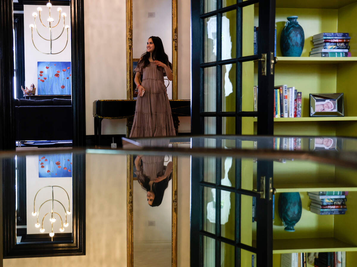 Sophie Retzlaff leads guests on tours of the Andrews-Duncan House during a fundraising event for CASA, an affordable housing nonprofit, on Tuesday, May 16, 2023, in Raleigh, N.C. Retzlaff stands in the entryway next to a mirror that is original to the house prior to renovations.