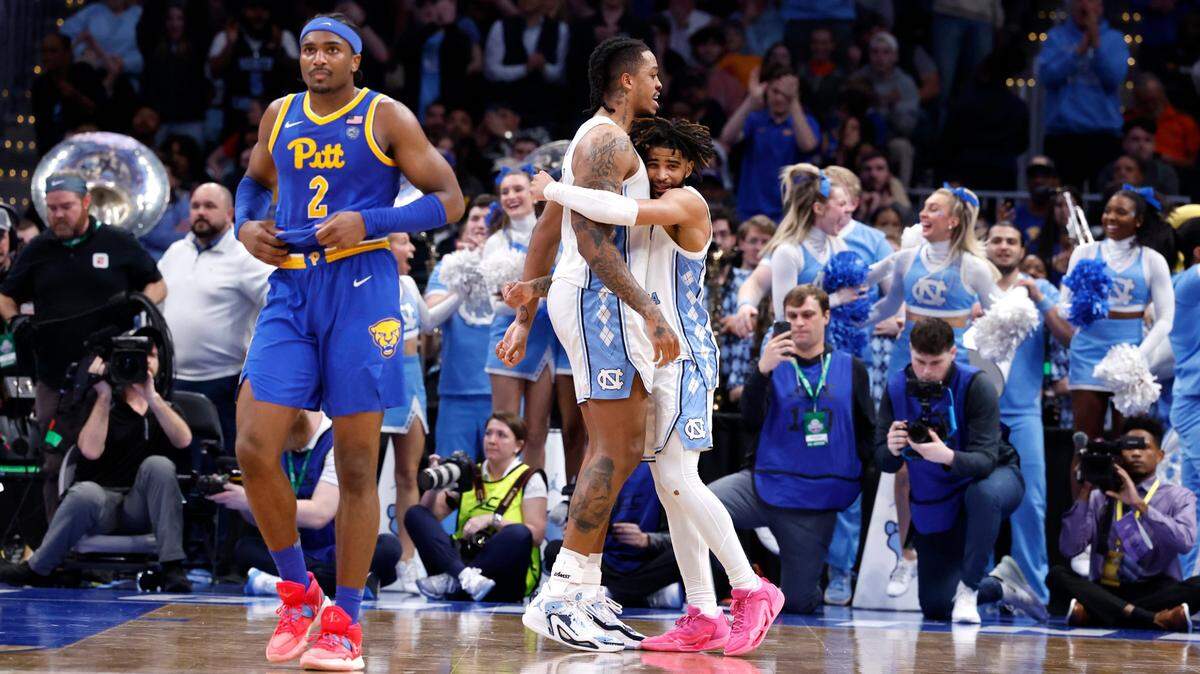 North Carolina’s RJ Davis (4) and Armando Bacot (5) hug as time runs out in UNC’s 72-65 victory over Pitt in the semifinals of the 2024 ACC Men’s Basketball Tournament at Capital One Arena in Washington, D.C., Friday, March 15, 2024.