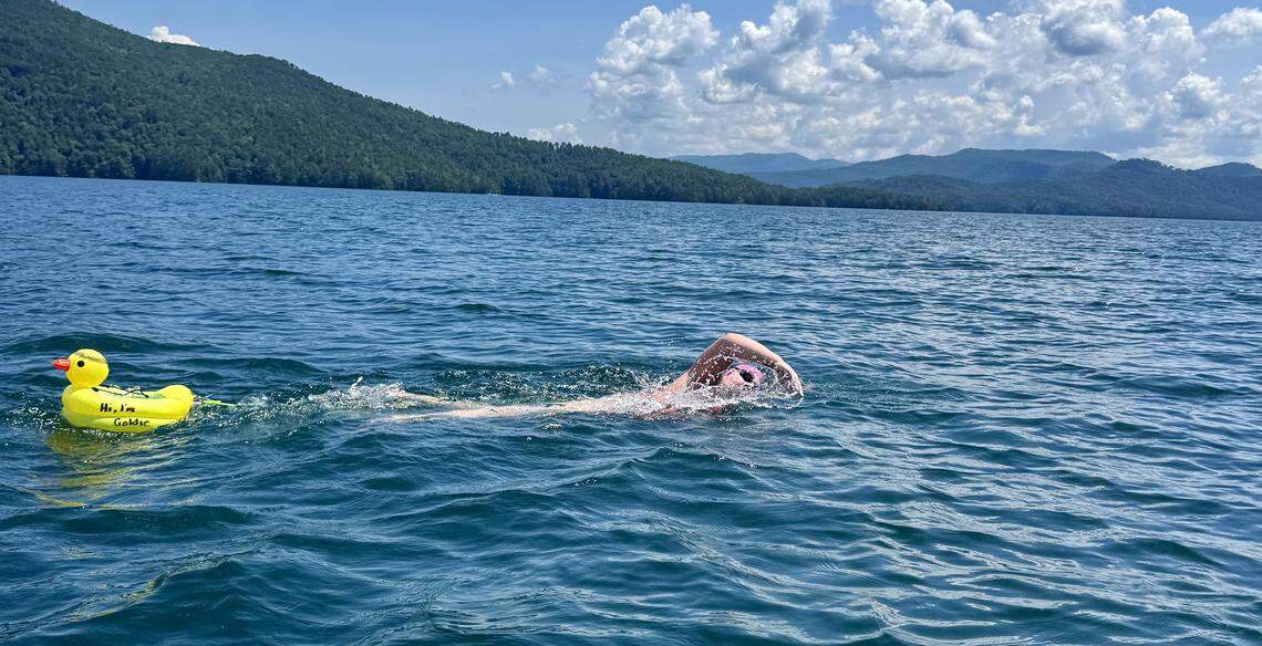 Lorelei Schmidt swims with a yellow duck buoy to warn boat traffic of her presence at Lake Jocassee in South Carolina. 