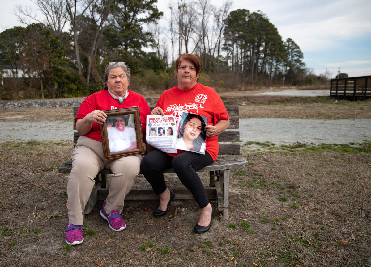 Angela Baxley, left, and Shelia Price hold photos of their deceased relatives. Both have had their stories told on the Red Justice Project, a true crime podcast devoted to bringing attention to violence against Indigenous people in North Carolina and beyond.