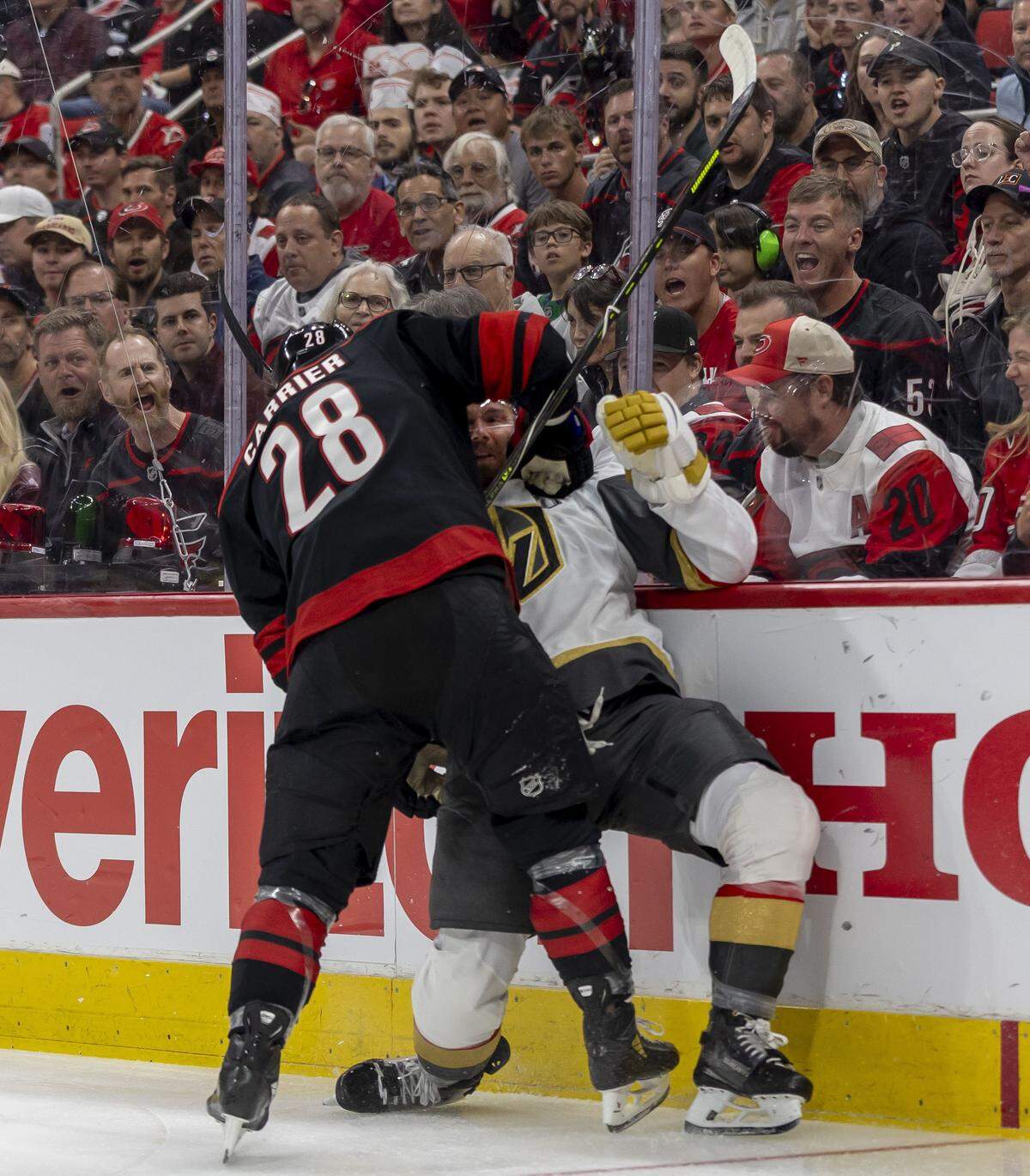 Carolina left wing William Carrier (28) checks Las Vegas defenseman Jeremy Lauzon (5) into the boards in the first period in Game 1 of the Stanley Cup Finals, on Tuesday, June 2, 2026 at Lenovo Center in Raleigh, N.C. 