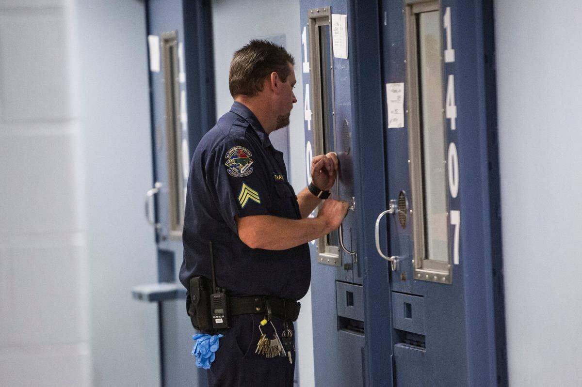 This file photo shows an N.C. corrections officer checking on an inmate at Central Prison in Raleigh.