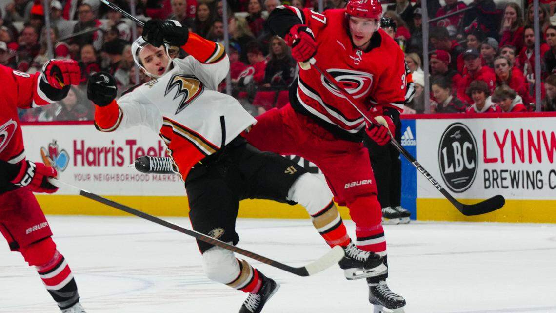 Jan 11, 2024; Raleigh, North Carolina, USA; Carolina Hurricanes right wing Andrei Svechnikov (37) checks Anaheim Ducks left wing Alex Killorn (17) during the second period at PNC Arena. Mandatory Credit: James Guillory-USA TODAY Sports