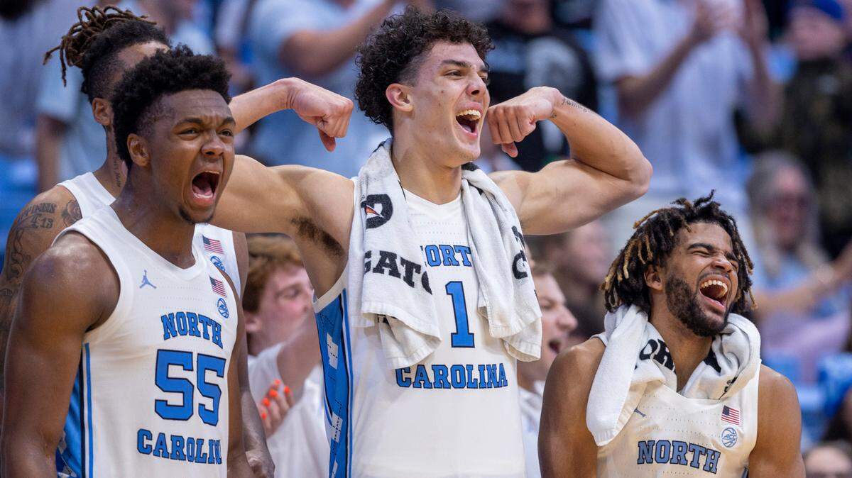 North Carolina’s Harrison Ingram (55), Zayden High (1) and R.J. Davis (4) celebrate after a basket by reserve player Duwe Farris (34) to give the Tar Heels’ a 113-53 lead against St. Augustine’s on Friday, October 27, 2023 at the Smith Center in Chapel Hill, N.C.