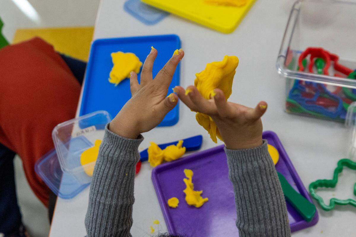 Pre-schoolers play with Play-Doh at the Early Learning Center at Memory Road, Thursday, Nov. 30, 2023. The Center is Wake County’s first standalone Pre-K center with space for up to 132 students.