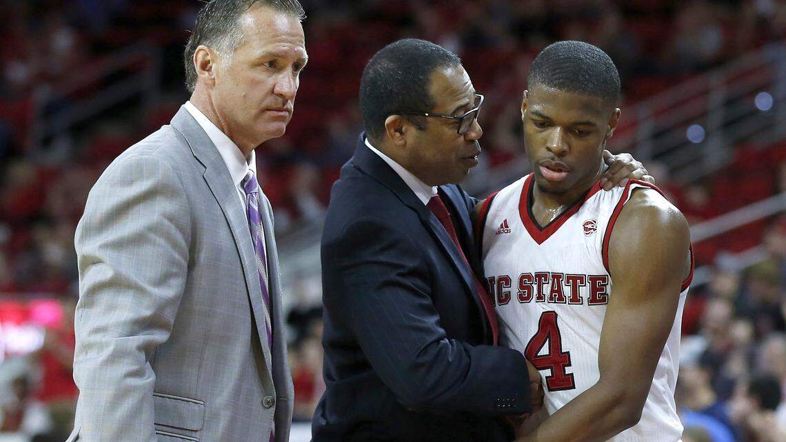 N.C. State coach Mark Gottfried, left, and assistant coach Orlando Early talk with Dennis Smith Jr. during the Wolfpack’s 99-78 victory over Fairfield at PNC Arena in Raleigh, N.C., Sunday, Dec. 18, 2016.
