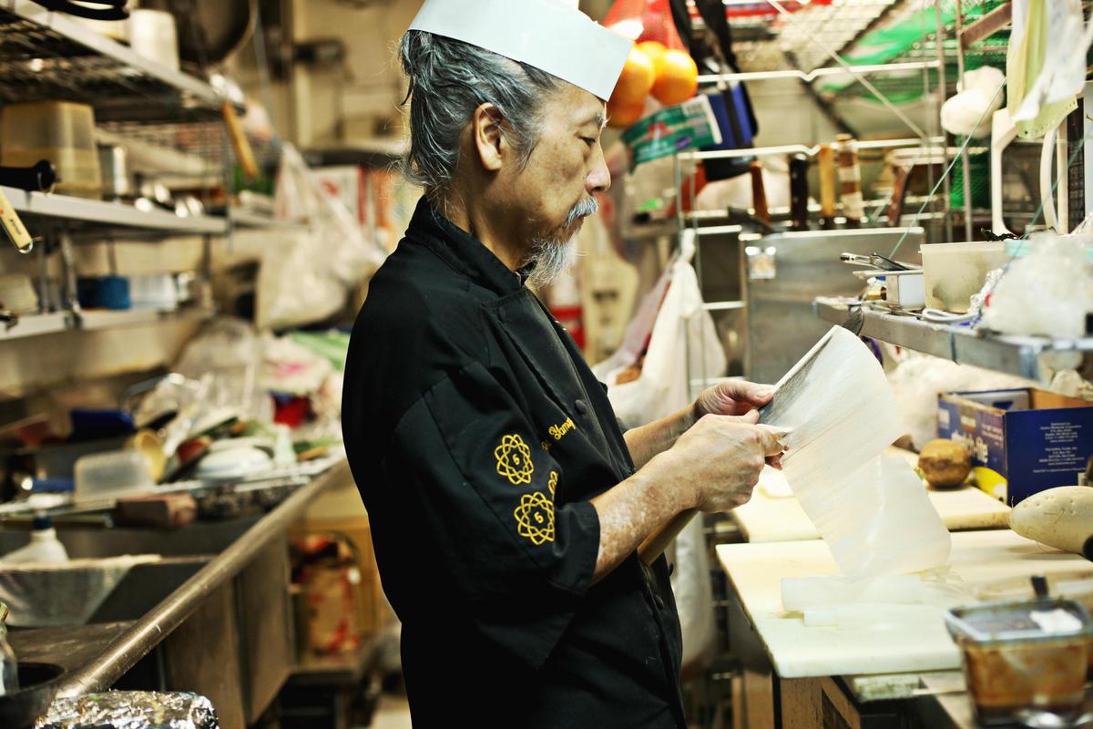 Chef George Yamazawa demonstrates a highly-skilled technique called katsuramuki to cut daikon radish into paper-thin sheets to create a long scroll in his Durham restaurant, Yamazushi, in 2015. The restaurant focuses on kaiseki dining which is a highly refined form of multi-course dining where every detail of the meal is artfully orchestrated, and nothing happens without careful thought and intentional purpose.