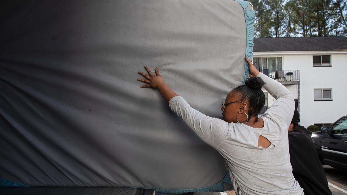 Portia Watson loads her belongings into a U-Haul truck while moving out of her apartment in Durham, N.C. on Friday, Dec. 30, 2022. Watson says she received notice that her lease would not be renewed after she took in neighbors from the same complex.