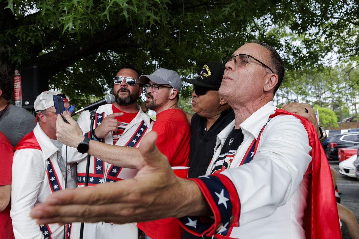 Matt Carden, (from right) a member of the CaneEvels fan group, sings alongside his buddies Jesse Sandoval, Ryan McCauley, Adam Averkamp and Donnie Robinson, in the parking lot outside the Lenovo Center on June 11, 2026, in Raleigh, North Carolina. The Carolina Hurricanes take on the Vegas Golden Knights for Game 5 of the Stanley Cup Final.