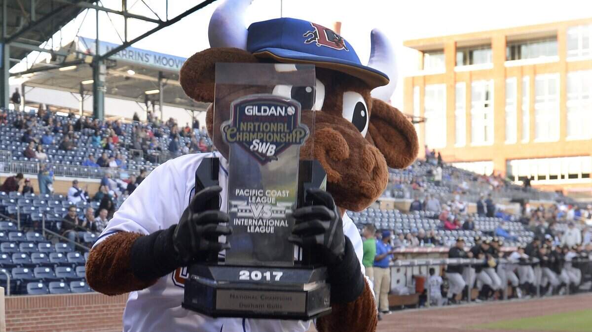 Bull’s mascot Wool E. Bull holds up the 2017 Triple A National Championship trophy as the Bulls open the 2018 season in April.