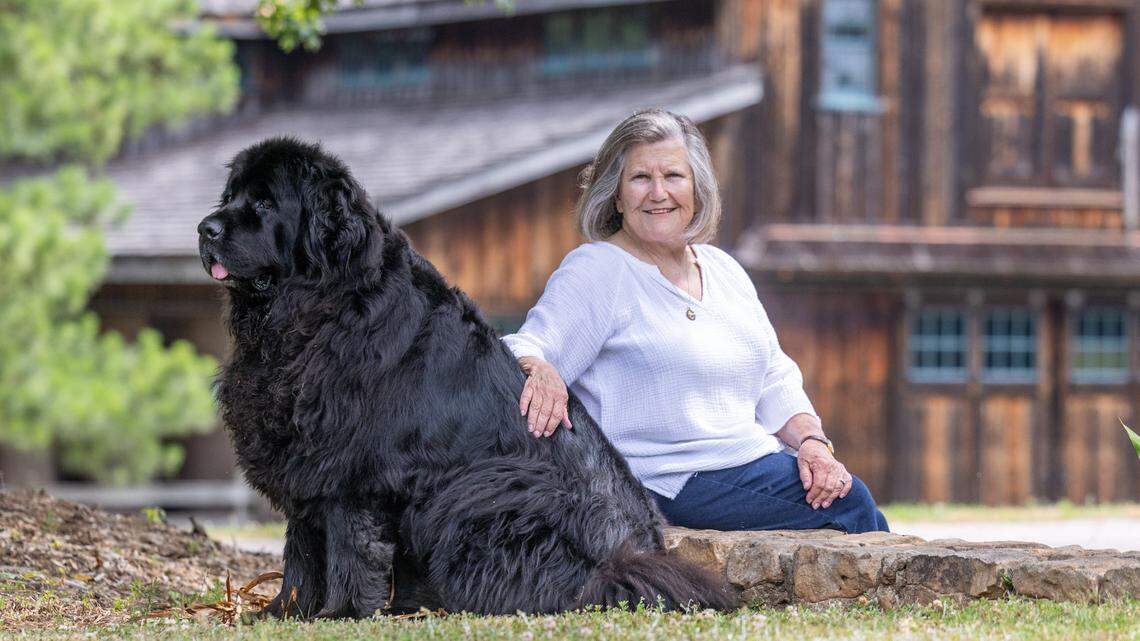 Susan Ward, a retired artist and philanthropist, poses with her Newfoundland dog “Mae” outside her home in Raleigh. Ward recently made a $5 million donation to Wake County SPCA.