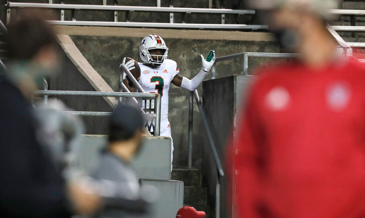Miami wide receiver Mike Harley (3) celebrates after running into the stands after pulling in a 20-yard touchdown reception during the first half of N.C. State’s game against Miami at Carter-Finley Stadium in Raleigh, N.C., Friday, Nov. 6, 2020.