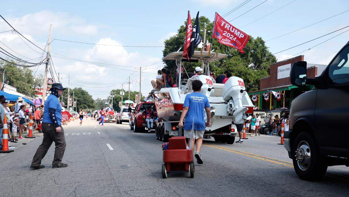 A boat with Donald Trump and Mark Robinson flags participates the annual Lumbee Regional Development Association’s Lumbee Homecoming Parade in Pembroke, N.C., Saturday, July 6, 2024.