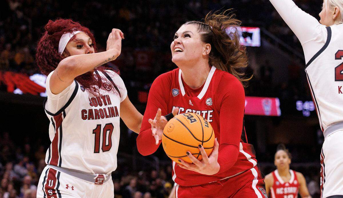 N.C. State’s River Baldwin drives to the basket past South Carolina’s Kamilla Cardoso during the first half of the Wolfpack’s Final Four matchup at Rocket Mortgage FieldHouse on Friday, April 5, 2024, in Cleveland, Ohio.