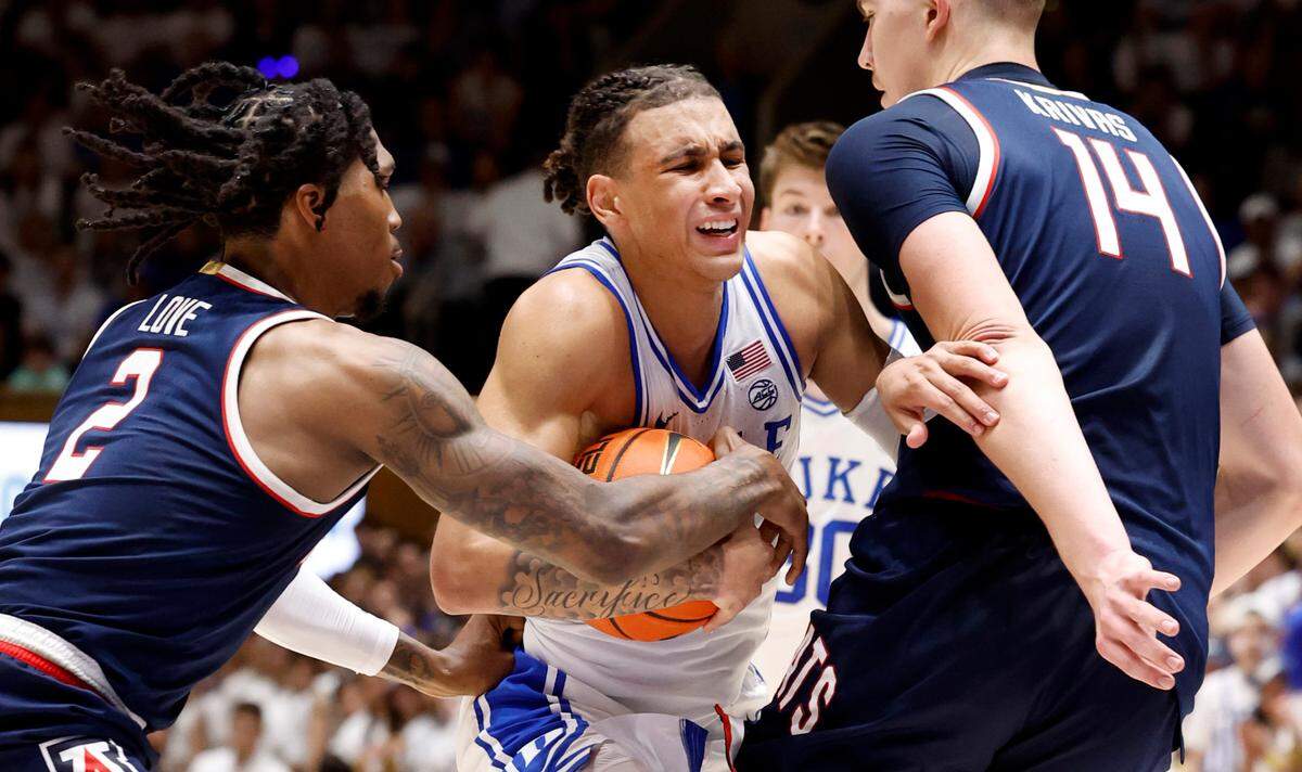 Duke’s Tyrese Proctor (5) tries to get by Arizona’s Caleb Love (2) and Motiejus Krivas (14) during the first half of Duke’s game against Arizona at Cameron Indoor Stadium in Durham, N.C., Friday, Nov. 10, 2023.